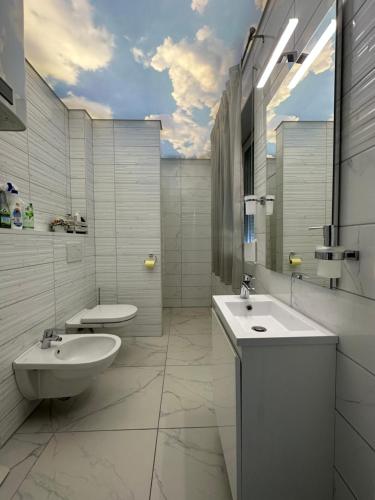 a white bathroom with a sink and a toilet at KAISER'S Freundschaft in Klagenfurt