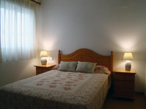a bedroom with a bed with two night stands and two lamps at Maestro Bayarri HC-2D in Peñíscola