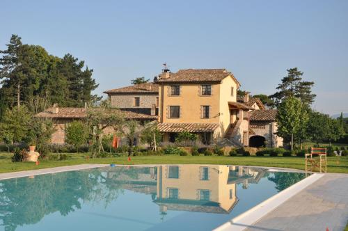 a villa with a swimming pool in front of a house at Ca' Matra in Lama