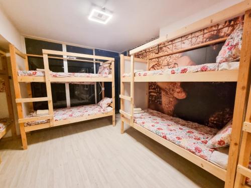 a room with three bunk beds in a house at Unique City Hostel 100 meters from Beach in Larnaca