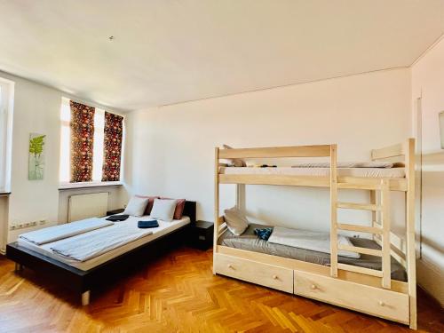 a room with two bunk beds and a couch at BISHNU HOSTEL in Zagreb