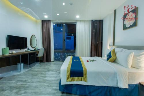 a hotel room with a large bed and a television at Ciao Saigon 2 Hotel in Ho Chi Minh City