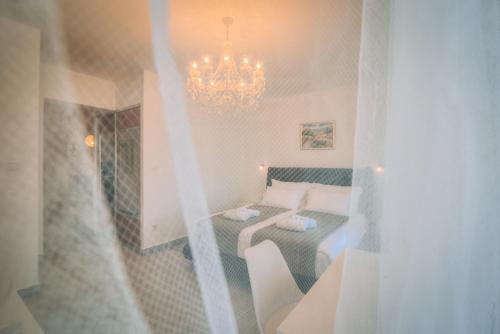 a room with a bed and a chandelier at LUMIN 4 in Senj