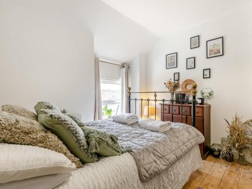 a bedroom with a bed with pillows on it at Sycamore Cottage in Praze an Beeble