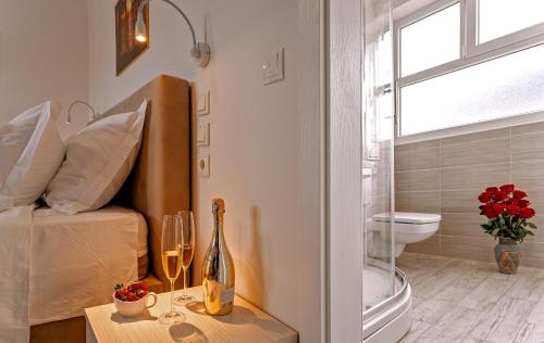 a bedroom with a bed and a window and a table with wine glasses at Villa Zvonko in Split