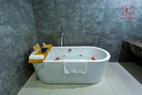 a bath tub in a bathroom with red stars on it at Ciao Saigon 2 Hotel in Ho Chi Minh City