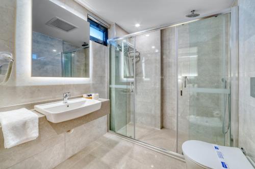 a bathroom with a sink and a shower at Kahya Hotel in Alanya