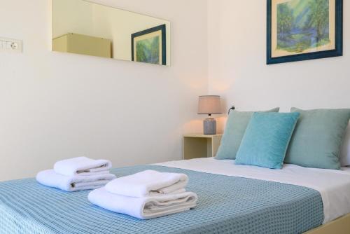 a room with a bed with towels on it at Artemis apartment first floor in Elounda