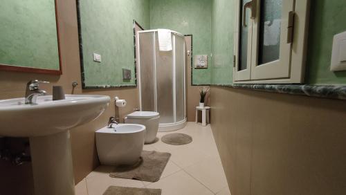 a bathroom with a sink and a toilet and a shower at Appartamenti in Villa Polimnia in Fontane Bianche
