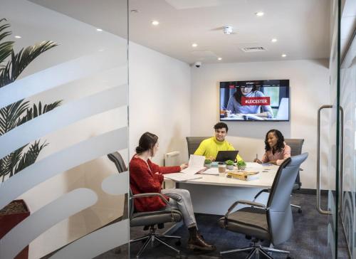 a group of people sitting at a table in a meeting room at Reynard House in Leicester in Leicester