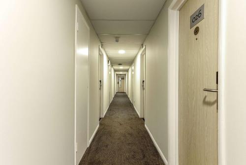 a long corridor with white walls and a long hallway at Days Inn Hotel Gretna Green in Gretna Green