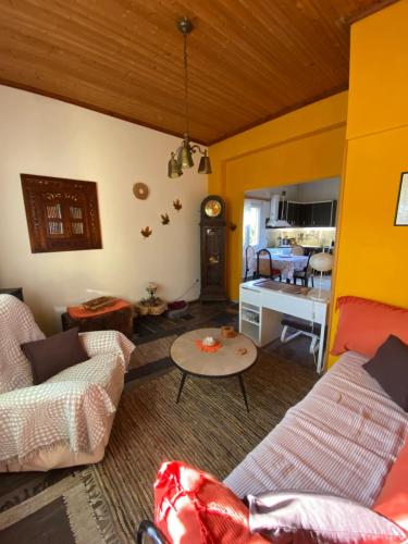 a living room with two couches and a table at Spiti Eutychia in Ayía Eléni