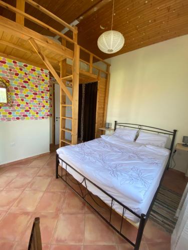 a large bed in a room with a wooden ceiling at Spiti Eutychia in Ayía Eléni