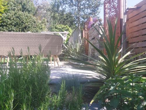 a garden with a chair and a plant at Beach House, with BBQ lodge and Hot Tub! in Bournemouth