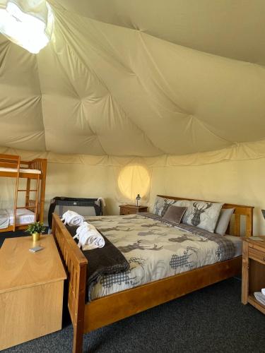 a bedroom with a bed in a tent at Dukeries Retreat in Retford