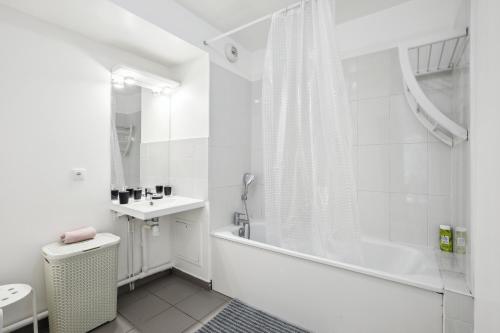La salle de bains est pourvue d'une baignoire, de toilettes et d'un lavabo. dans l'établissement Chic apart with terrace and parking, aux Ulis