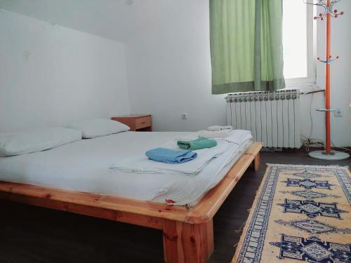 a bedroom with a bed with a wooden frame at Hostel Hayat in Sarajevo