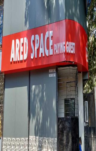 a sign for aaret space paying guest on a building at Ared Space-Near Vile Parle Railway Station in Mumbai