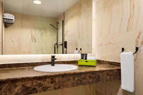 a bathroom with a sink and a mirror at La Quinta by Wyndham Dubai Jumeirah in Dubai
