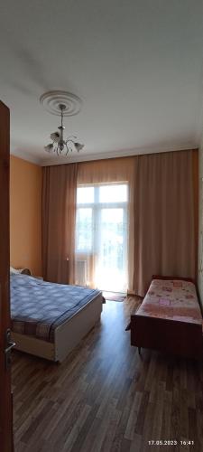 a bedroom with two beds and a window at Olesya Guesthouse in Mtsvane Kontskhi