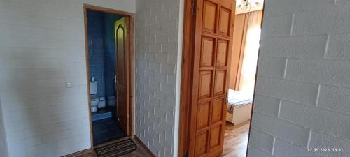 a bathroom with a mirror next to a wall at Olesya Guesthouse in Mtsvane Kontskhi