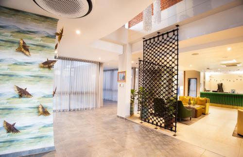 a lobby with a large painting of dolphins on the wall at Angels View Hotel in Graskop