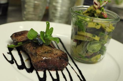 a plate of food with a salad in a jar at Landhotel Binderhäusl Garni in Inzell