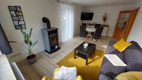 a living room with a couch and a wood stove at Ferienhaus Flessenow am Schweriner See in Flessenow
