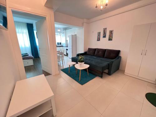 a living room with a couch and a table at Central Metropolitan Bright 1 in Iaşi
