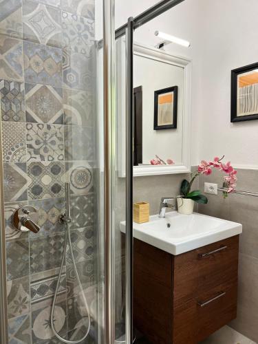 a bathroom with a sink and a shower at Bnbook Casa Luccio VistaLago Ispra in Ispra