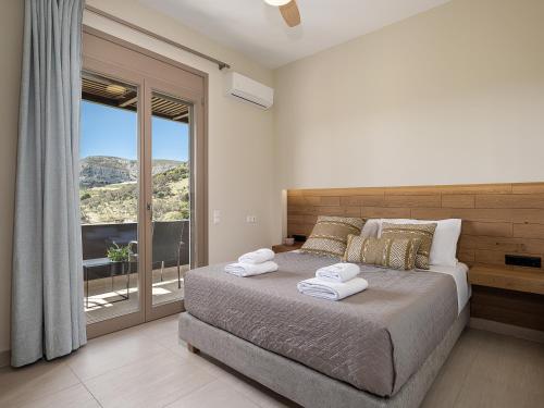 a bedroom with a large bed with towels on it at Villa Amavi - Private heated pool in Kato Asites