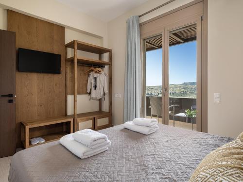 a bedroom with a large bed with towels on it at Villa Amavi - Private heated pool in Kato Asites