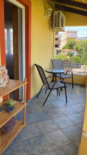 a patio with a table and chairs on a floor at Spiti Eutychia in Ayía Eléni
