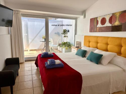 a bedroom with a large bed with two towels on it at Calatabarca B&B in Tabarca