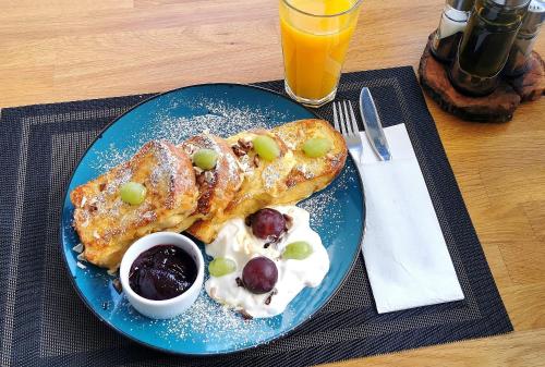 a blue plate with two pastries and fruit on it at Willa Pieńkowskich in Gdynia
