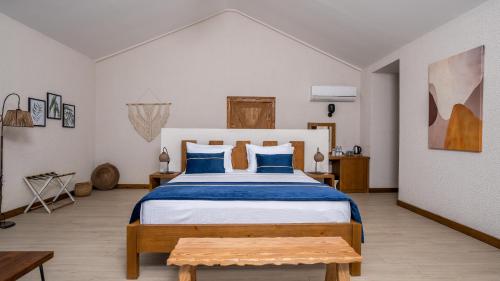 a bedroom with a large bed with blue pillows at Vista Del Amor Faralya in Fethiye