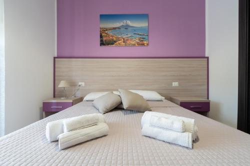 a bedroom with a large bed with two white pillows at L'Orto del Conte in Naples