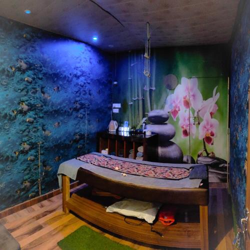 a room with a bed in front of a fish mural at The Royal Bhumesh in Katra