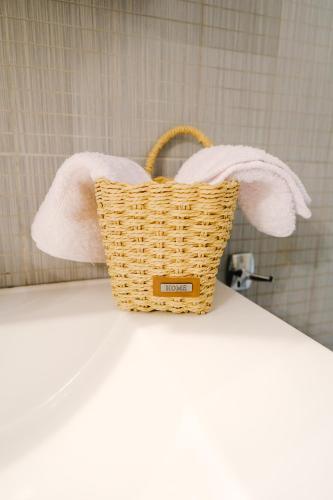 a basket sitting on top of a counter with towels at Oasis Garden House in Iraklitsa