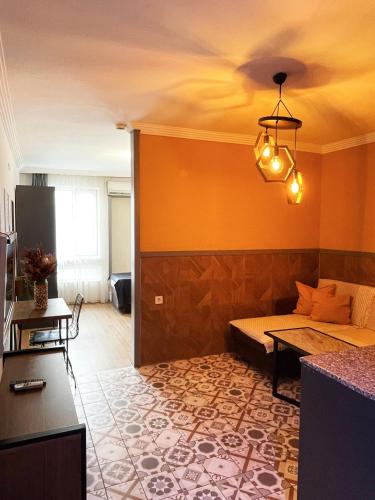 a living room with a bed and a table in it at Beta GuestHouse in Antalya