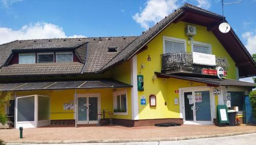a yellow building with a balcony on it at Apartment Lucija-Terme Šmarješke Toplice in Smarjeske Toplice