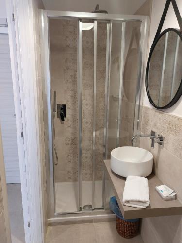 a bathroom with a shower and a white sink at Hotel San Domingo in Lido di Camaiore