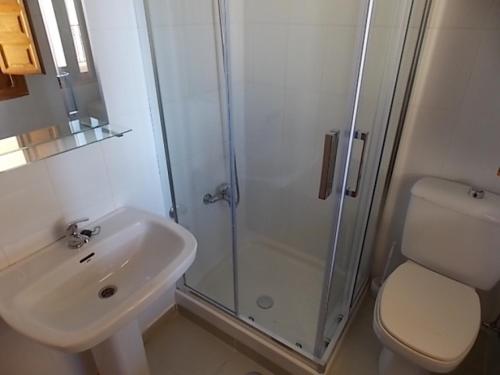 a bathroom with a sink and a shower and a toilet at Puertosol in Puerto de Mazarrón