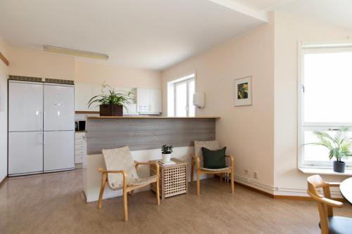 a kitchen and dining room with a table and chairs at Härnösands folkhögskolas Bed & Breakfast in Härnösand