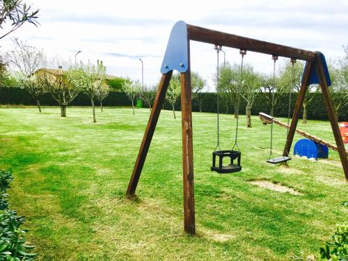 an old swing set in a park at Agriturismo Il Casale in Morrovalle