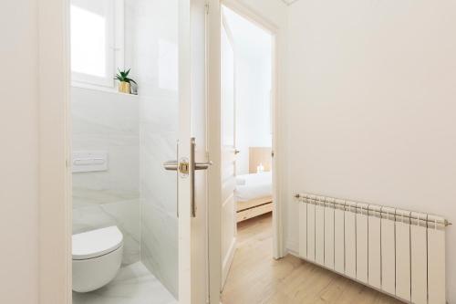バルセロナにあるスイーツ4デイズ ガウディ アシャンプラの白いバスルーム(トイレ、窓付)