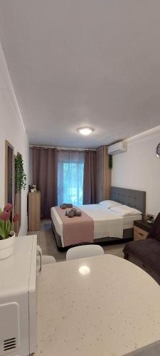 a hotel room with two beds and a table at Stay With Oleg C17 in Paralimni