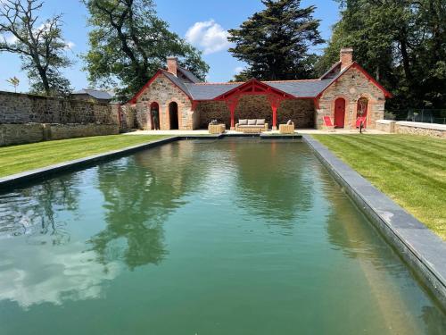 a large pool of water in front of a house at Chateau LE BROSSAY in Renac