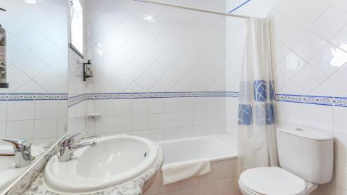 a bathroom with a sink and a tub and a toilet at Luminous 3BDR Apartment W/Balcony by LovelyStay in Vila Nova de Cacela