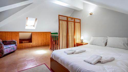 a bedroom with a large white bed with two towels on it at Luminous 3BDR Apartment W/Balcony by LovelyStay in Vila Nova de Cacela